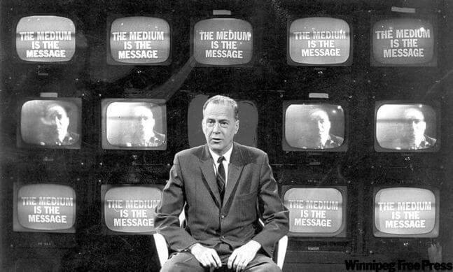 Marshall McLuhan - the medium is the message, displayed on a wall of TVs