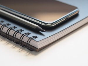 Notebook, pencil, phone