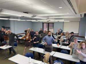 NMC faculty doing the robot at a GenAI workshop
